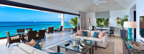 This image features an elegant and spacious interior that seamlessly opens up to a stunning ocean view