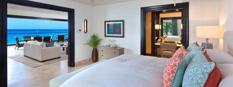 The image shows a luxurious bedroom suite with a seamless blend of indoor and outdoor spaces