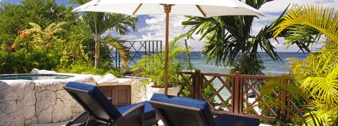 The image shows a tranquil and inviting outdoor terrace of a tropical resort