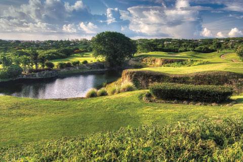 The image shows a beautifully landscaped golf course