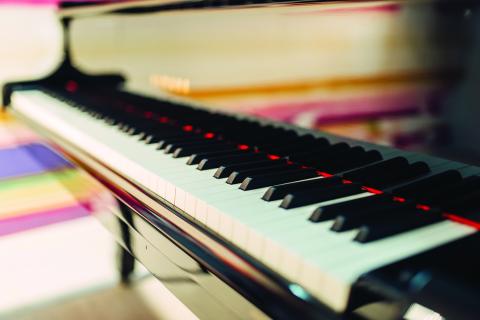 This image features a close-up view of a piano keyboard