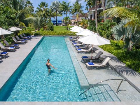 This image shows a luxurious pool area at a resort