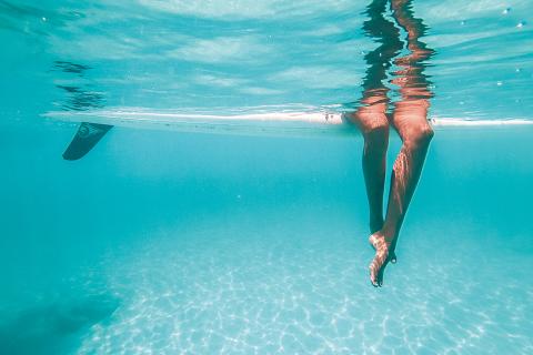 This image captures the underwater view of a person diving or swimming