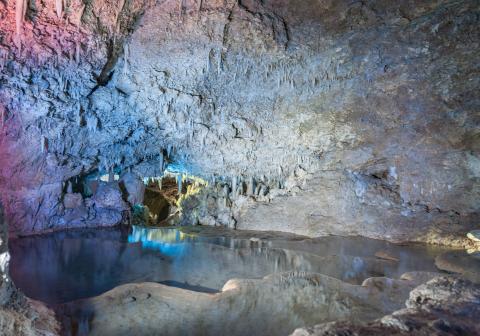 This is an image of the interior of a cave, showcasing a variety of geological formations