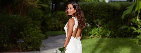 This image features a woman dressed in a formal white gown, suggesting it could be a wedding dress