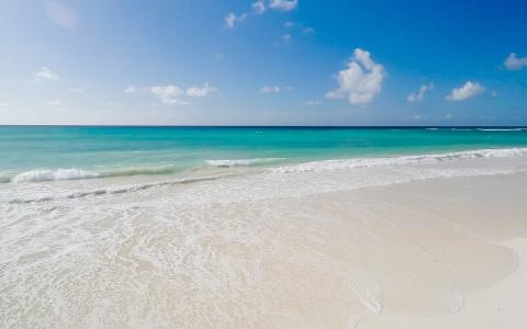 The image shows a beautiful and serene beach scene