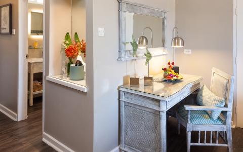 This image features a stylish, cozy dining area adjacent to what appears to be the entrance to a bathroom