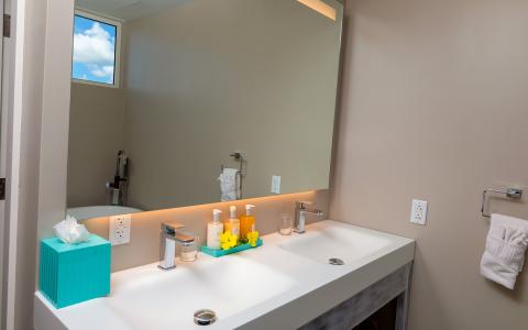 The image shows a modern bathroom vanity area