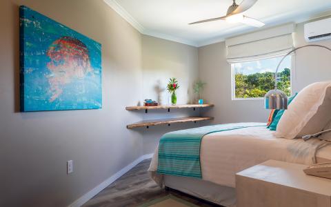 The image shows a modern and well-decorated bedroom