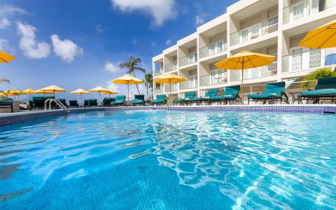 This image shows a luxurious outdoor swimming pool area of a hotel or resort