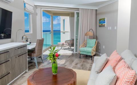 The image shows a modern and stylish interior of a beachfront apartment