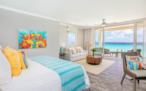 This image displays a brightly decorated beachfront hotel room
