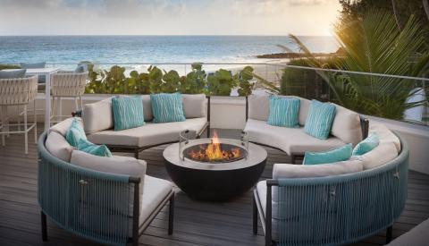 This image showcases an outdoor seating area with a luxurious and comfortable setup, perfect for relaxation or gatherings