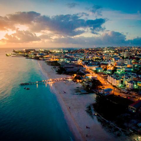 This image captures a beautiful aerial view of a coastal city at dusk