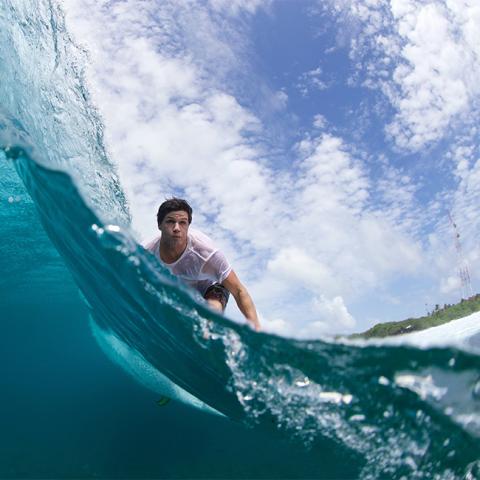 This image captures a moment of aquatic adventure, showing a person surfing