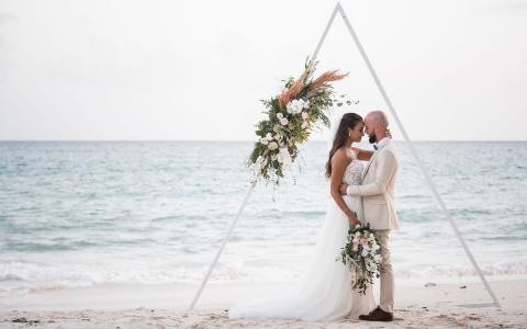 This image captures a beautiful beach wedding scene