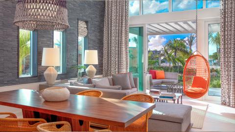This image shows a stylish and modern living room interior that blends indoor and outdoor elements seamlessly