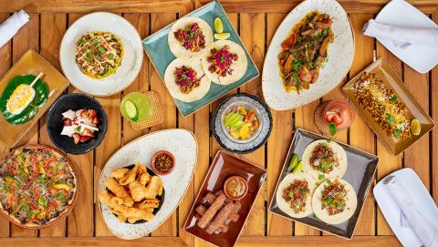 overhead photo of a variety of food dishes on a table