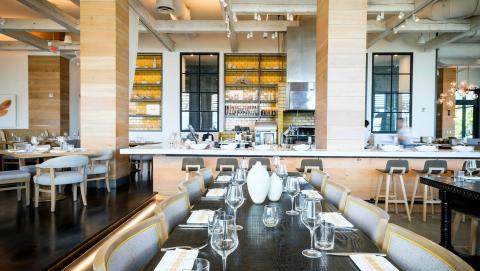 The image depicts the interior of a modern and stylish restaurant