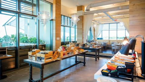 This image depicts a modern, stylish buffet area inside a spacious dining hall