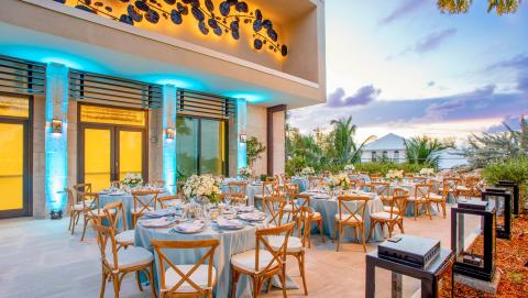 This image shows an elegantly set up outdoor dining area at dusk