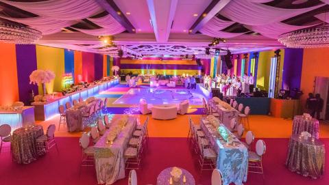 This image depicts a lavishly decorated event hall set up for a celebration or a party