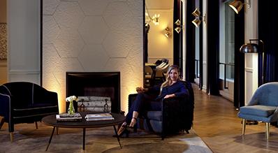 The image features a stylish interior setting that appears to be a lobby or lounge area