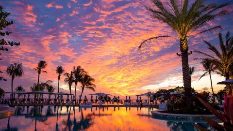This image shows a beautiful sunset with a vibrant sky filled with shades of pink, purple, and orange