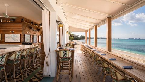 This image shows a beautifully designed beachfront bar or restaurant