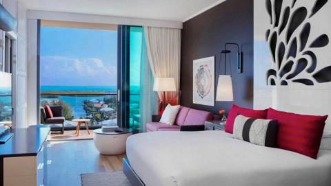 This image shows a luxuriously appointed hotel room with a modern aesthetic