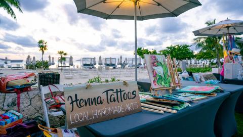 This image depicts an outdoor market or vendor setup by the beach