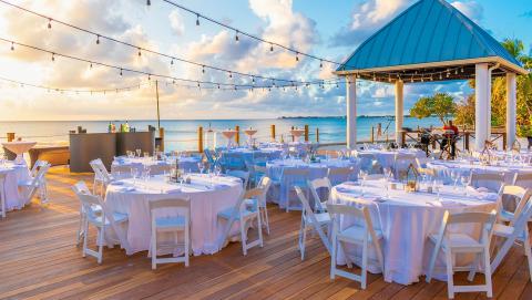 This is a beautifully arranged outdoor dining setup at a beachside location
