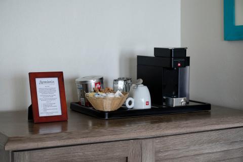 This image features a setup of a coffee station that includes various items:

1