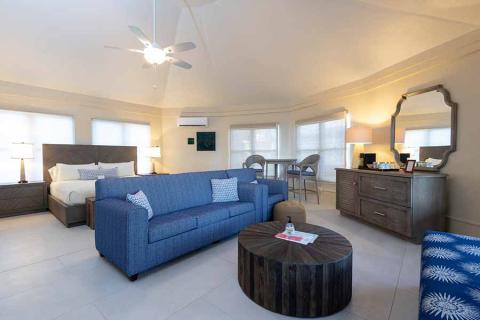 The image shows a spacious and well-appointed hotel room or suite
