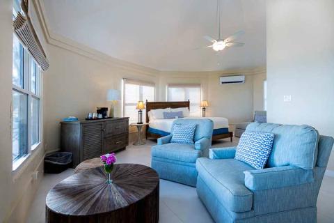 The image shows a well-furnished hotel or resort room