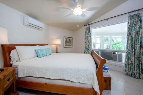The image shows a well-lit, tidy bedroom