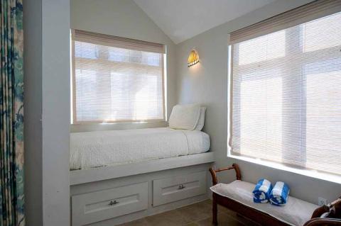 This image features a neatly arranged interior room, possibly a bedroom or a guest room