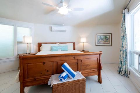 This image shows a neatly arranged, bright bedroom