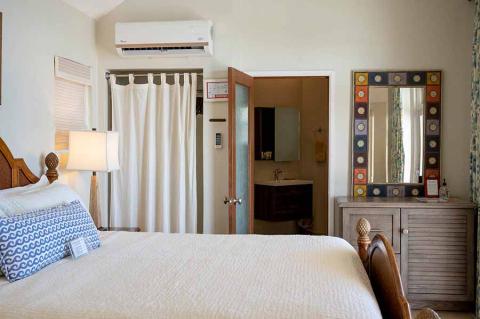 This image shows a well-lit, tidy bedroom