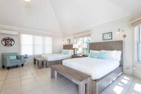 The image shows a well-lit, spacious hotel or resort room