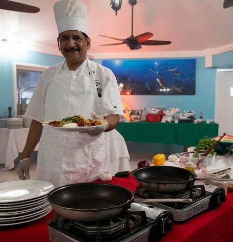 This image shows a chef in a professional kitchen setting