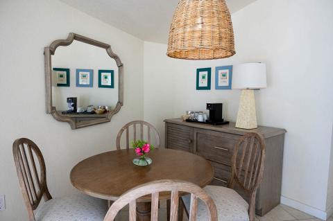 This image depicts a neatly arranged dining area in a room with a contemporary aesthetic