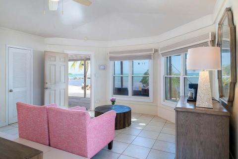 The image shows a bright and airy beach-style living room