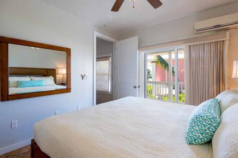 The image shows a bright and airy bedroom