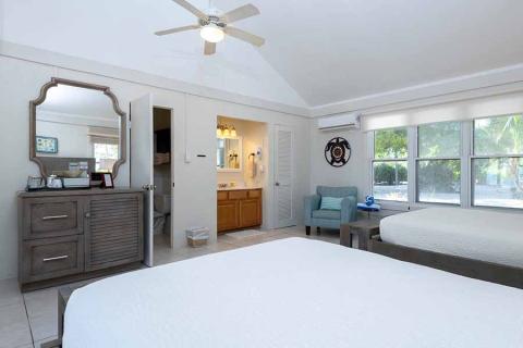 The image shows a well-lit, spacious hotel room or guest room