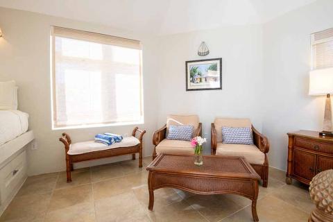 This image shows a neatly arranged interior of a room that has a tropical or beach-themed décor