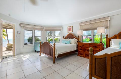 The image shows a beautifully appointed bedroom with a coastal theme
