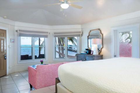 This image shows a bright and airy beachfront hotel room