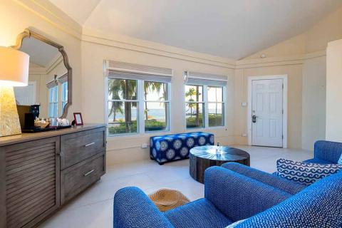 This image shows a stylish room with a beach view