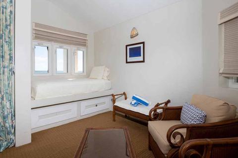 The image shows a neatly arranged room with a maritime or nautical theme